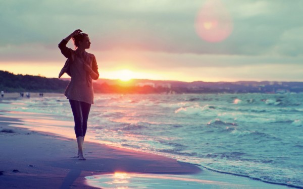 girl-walking-on-the-beach-at-sunset-600x375