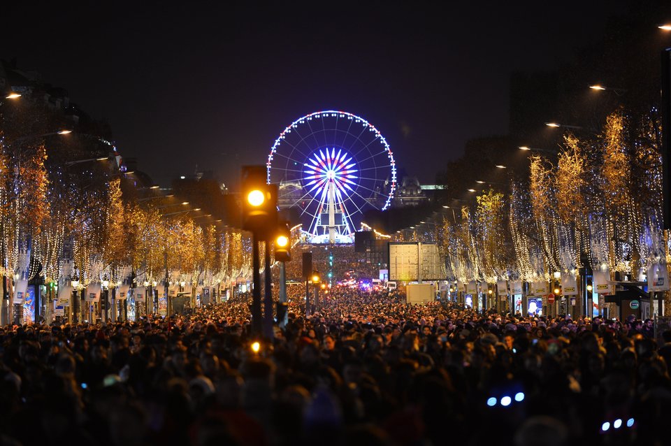 PARIS, FRANCE - JANUARY 01 : People attend New Year's celebrations at Champs Elysees Avenue on January 1, 2016 in Paris, France. (Photo by Mustafa Yalcin/Anadolu Agency/Getty Images)