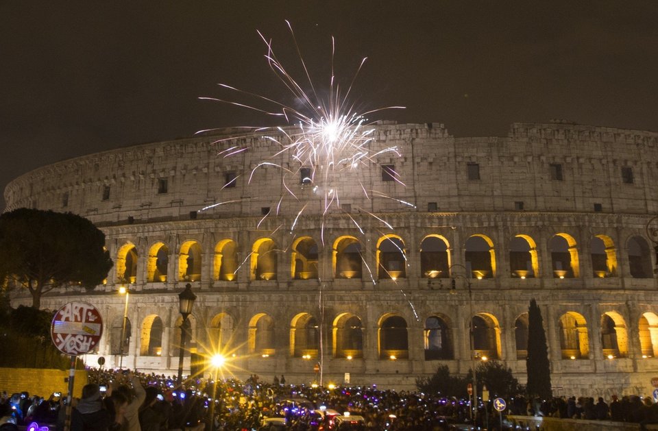 ROME, ITALY - JANUARY 1: Revelers celebrate the new year near the Colosseum after the clock strikes midnight in Rome, Italy on January 1, 2016. (Photo by Riccardo De Luca/Anadolu Agency/Getty Images)