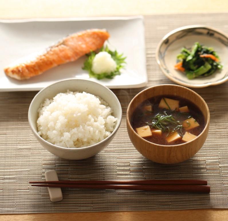 A hearty Japanese breakfast consisting of miso soup with tofu and scallions, salmon, rice and pickles. Credit: iStock kazoka30