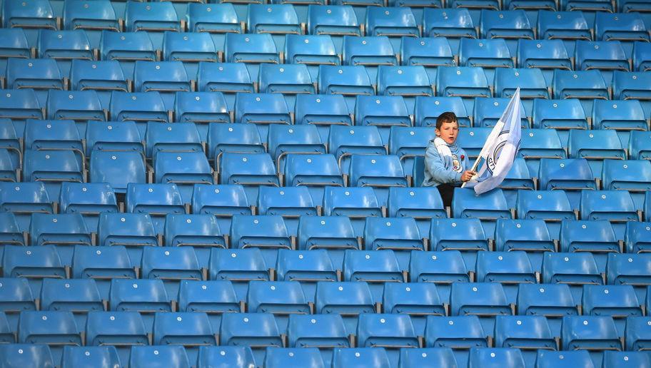 MANCHESTER, ENGLAND - NOVEMBER 05: A young Manchester City fan holds a Manchester City flag prior to kick off during the Premier League match between Manchester City and Middlesbrough at Etihad Stadium on November 5, 2016 in Manchester, England.  (Photo by Laurence Griffiths/Getty Images)