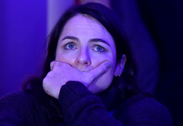 A woman reacts to the television coverage of U.S. Presidential election results during an election party at the U.S. embassy in London, Britain, November 9, 2016. REUTERS/Hannah McKay