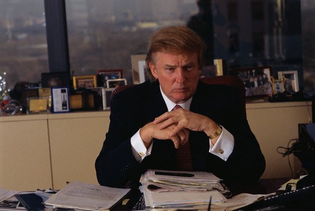Real estate developer Donald Trump sits at a desk in his office at the Trump Tower. --- Image by © Michael Brennan/CORBIS