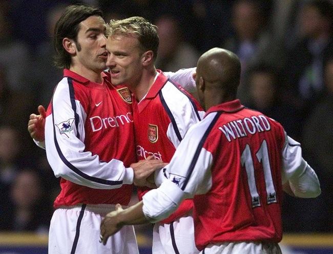 Arsenal's Dennis Bergkamp (centre) celebrates his goal with team mate Robert Pires (left) as they take the lead against Newcastle during their FA Barclaycard Premiership match at Newscastle's St James's Park ground. THIS PICTURE CAN ONLY BE USED WITHIN THE CONTEXT OF AN EDITORIAL FEATURE. NO WEBSITE/INTERNET USE UNLESS SITE IS REGISTERED WITH FOOTBALL ASSOCIATION PREMIER LEAGUE.
